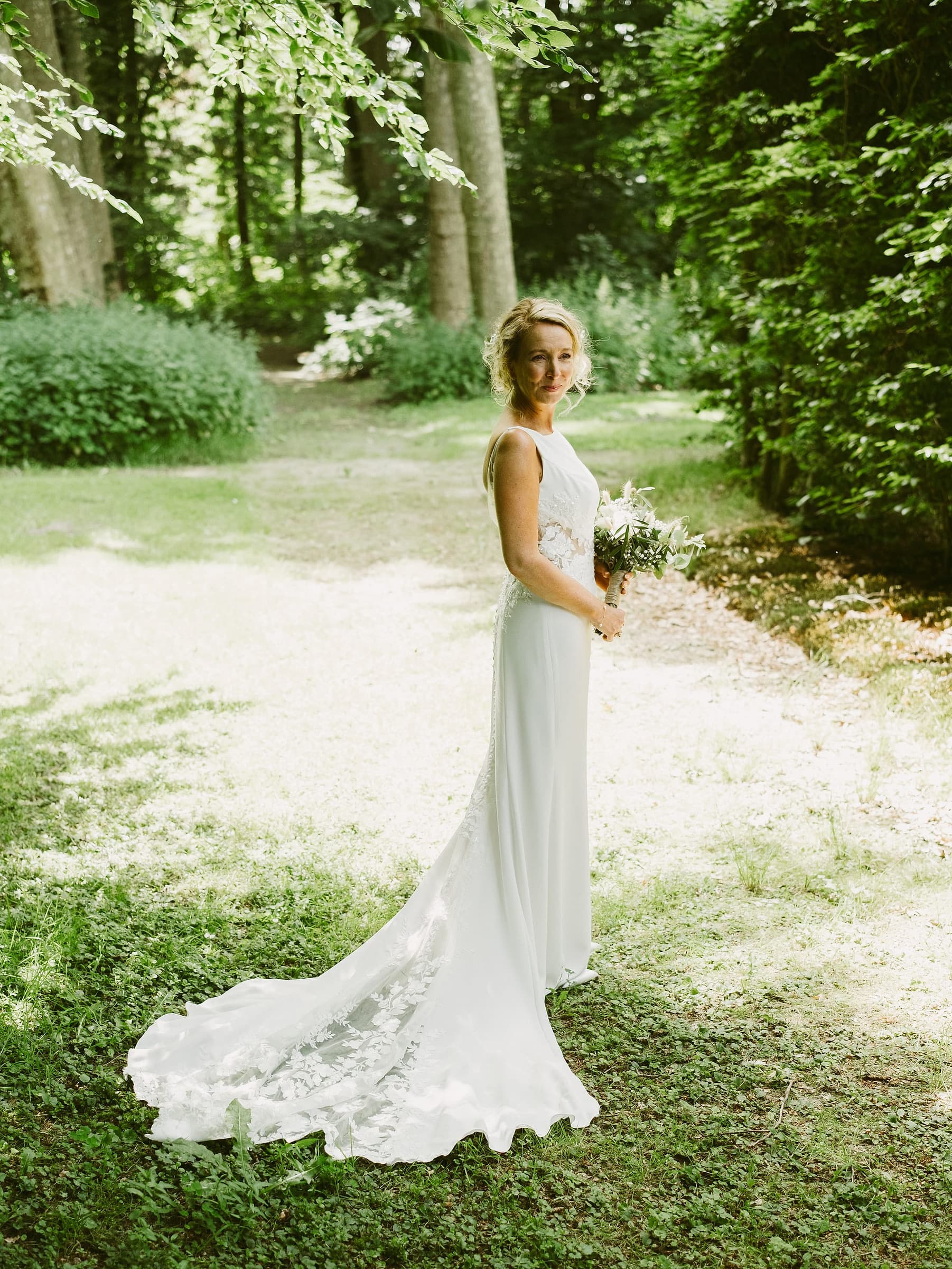 A bride to be smiling in natural light during an engagement session