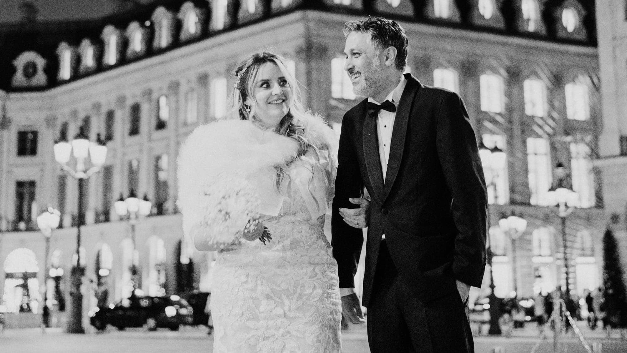 A wedding couple on a grand Paris street at night